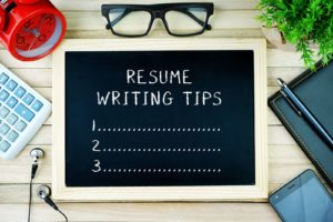 Chalkboard with the words "Resume Writing Tips" and "1. 2. 3."