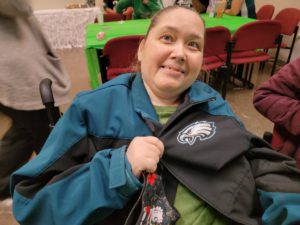 woman smiling with eagles gear