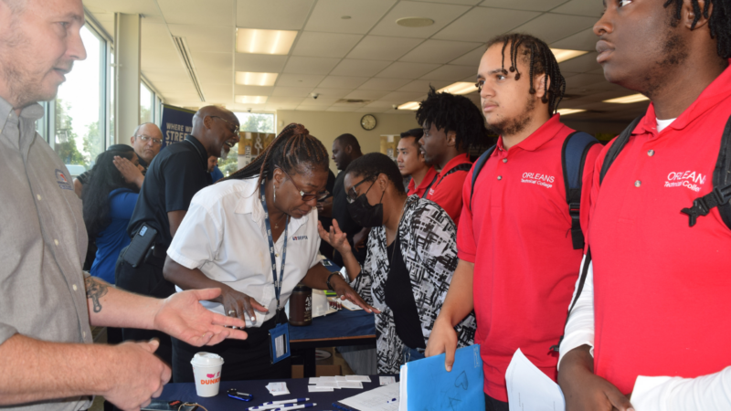 young men speaking to employer at a hiring fair