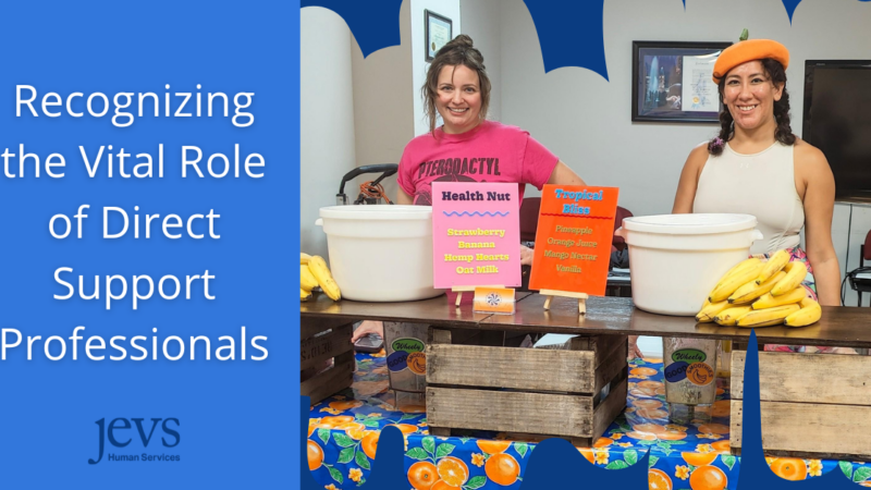 Two women standing behind a table with food times and smiling, with a blog title that says Recognizing the Vital Role of Direct Support Professionals