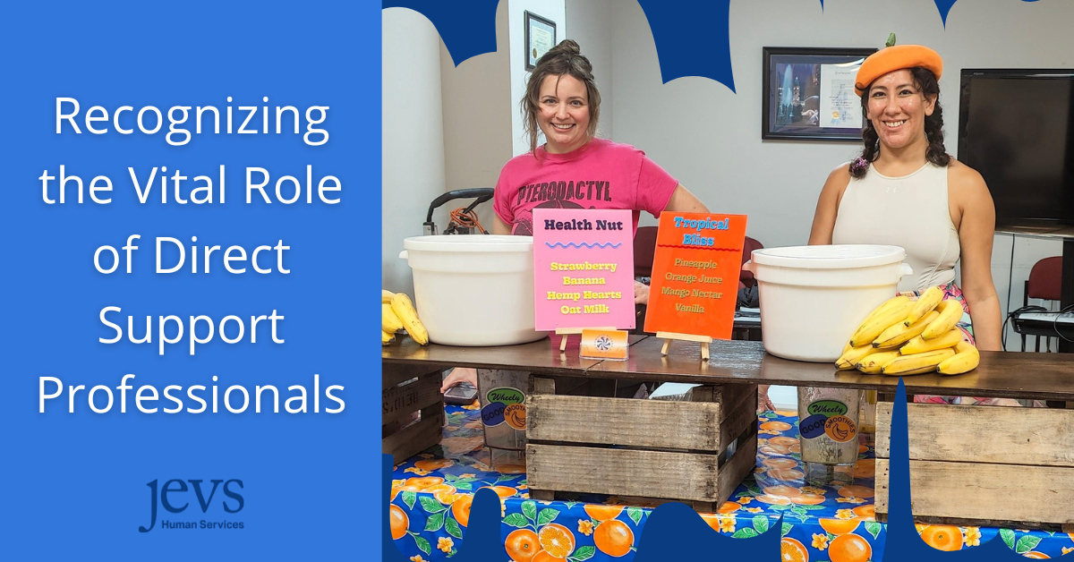 Two women standing behind a table with food times and smiling, with a blog title that says Recognizing the Vital Role of Direct Support Professionals